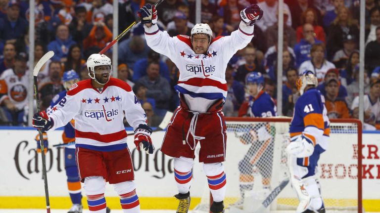Alex Ovechkin #8 and Joel Ward #42 of the Washington Capitals celebrate a third-period game-tying goal against the New York Islanders scored by teammate Nicklas Backstrom (not pictured) during Game 3 of the Eastern Conference quarterfinals at Nassau Coliseum on Sunday, April 19, 2015.