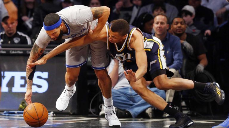 Brooklyn Nets vs. Utah Jazz 62 Deron Williams #8 of the Brooklyn Nets battles for a loose ball in the first half against Dante Exum #11 of the Utah Jazz at Barclays Center on Sunday, Mar. 8, 2015 in Brooklyn, New York.