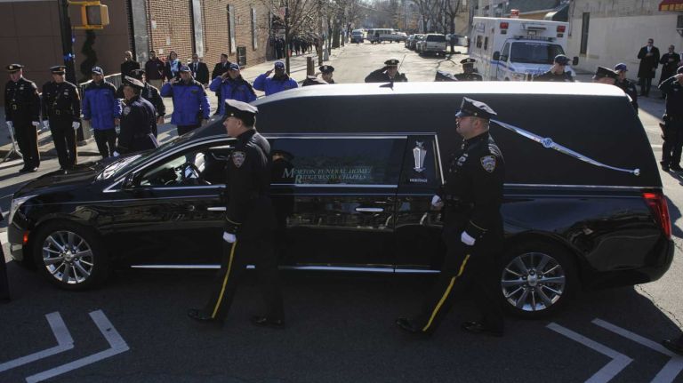Rafael Ramos, slain NYPD officer, remembered at Queens wake 28 A hearse carrying the coffin of NYPD Officer Rafael Ramos arrives at Christ Tabernacle Church in Queens on Friday, Dec. 26, 2014.