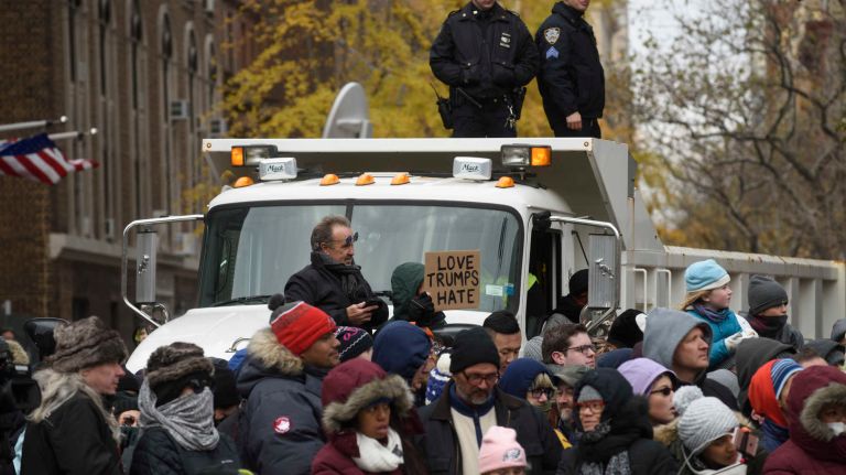 NYPD uniformed officers survey the crowds from city sand trucks that were parked to block side streets on Thursday, Nov. 24, 2016, along the route of the 90th annual Macy's Thanksgiving Day Parade from Central Park West to outside the Macy's store on Herald Square.
