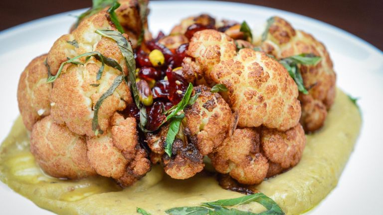 Wall Street Grill welcomes customers to the 'family' for Rosh Hashanah dinner 5 Roasted cauliflower with dried craisins, pistachio, pomegranate, and a saffron tahini emulsion at the Wall Street Grill, who is offering Kosher rooftop dining for Rosh Hashanah.