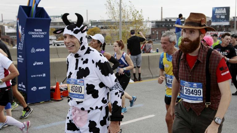 New York City marathon participants run along the race route in Brooklyn on Nov. 1, 2015.