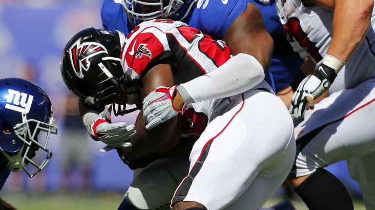defensive tackle Johnathan Hankins #95 of the New York Giants tackles running back Tevin Coleman #26 of the Atlanta Falcons during an NFL game at MetLife Stadium on Sunday, Sept. 20, 2015.