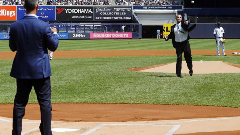 Andy Pettitte throws the ceremonial first pitch to former teammate Jorge Posada before a game between the New York Yankees and the Cleveland Indians at Yankee Stadium on Sunday, Aug. 23, 2015.