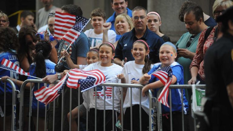 Fans wait for the World Cup champion U.S. women's soccer team's ticker-tape parade to start along the Canyon of Heroes in lower Manhattan on Friday, July 10, 2015.