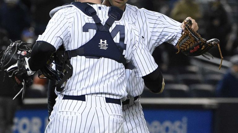 New York Yankees catcher Brian McCann and New York Yankees relief pitcher Chasen Shreve celebrate the 6-1 win against the New York Mets in a baseball game at Yankee Stadium on Friday, April 24, 2015.
