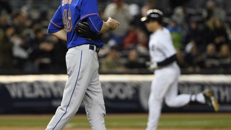 New York Mets starting pitcher Jacob deGrom stands on the mound as New York Yankees first baseman Mark Teixeira runs the bases on his two-run home run in the third inning of a baseball game at Yankee Stadium on Friday, April 24, 2015.
