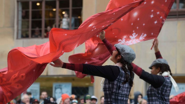 Spectators watch as entertainers perform along Central Park West on Thursday, Nov. 24, 2016, at the start of the 90th Macy's Thanksgiving Day Parade in Manhattan.