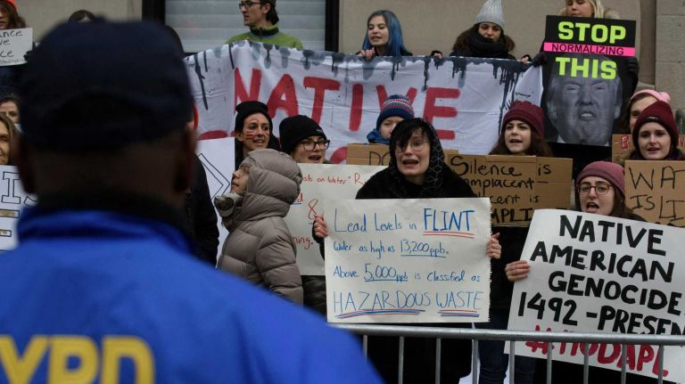 Demonstrators line Central Park West on Thursday, Nov. 24, 2016, near the starting point of the 90th Macy's Thanksgiving Day Parade in Manhattan.