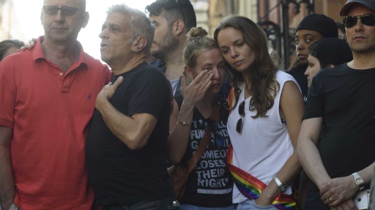 People gather at The Stonewall Inn in Manhattan on Sunday, June 12, 2016, at a vigil for Orlando, Fla., shooting victims. A gunman armed with an assault rifle and handgun killed 49 people and wounded 53 at Pulse, a gay nightclub in Orlando, in what officials termed the worst mass shooting in U.S. history.