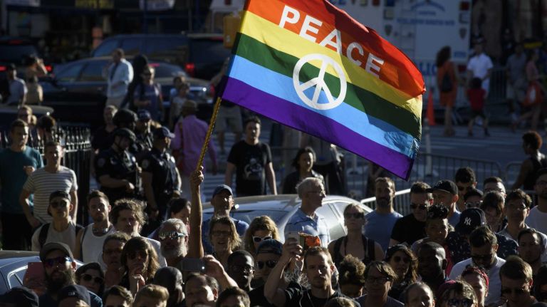 People gather at The Stonewall Inn in Manhattan on Sunday, June 12, 2016, at a vigil for Orlando, Fla., shooting victims. A gunman armed with an assault rifle and handgun killed 49 people and wounded 53 at Pulse, a gay nightclub in Orlando, in what officials termed the worst mass shooting in U.S. history.