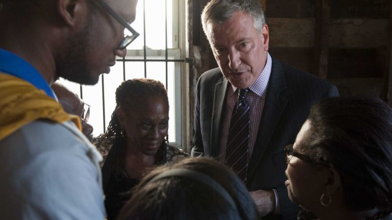 Bennet Bennet, left, Rudolph Bennet, Chirlane McCray, Gabriele Bennet, Democratic mayoral nominee Bill de Blasio, and Marcia Bennet, discuss the damage that superstorm Sandy did to the Bennets' home in Queens. McCray is de Blasio's wife. (Sept. 29, 2013)