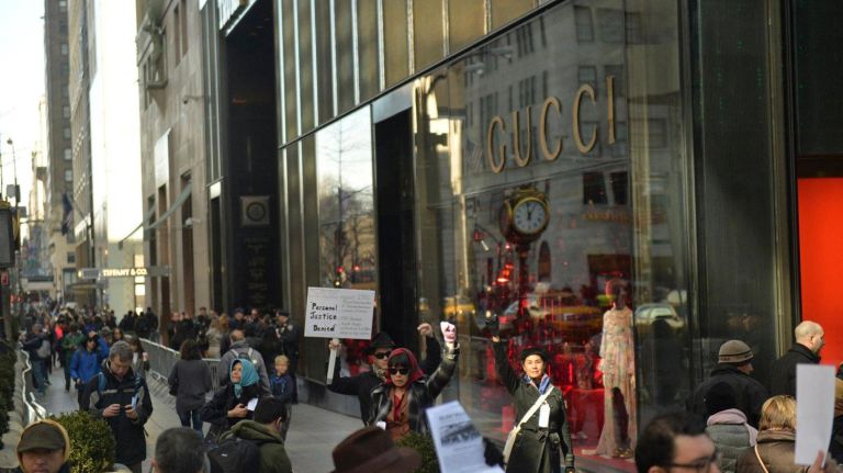 Karen Lee, the lead organizer of a Silent Peace March (right) and about two dozen others pause in front of Trump Tower in Manhattan on Saturday, Feb. 18, 2017. 75 years ago, President Franklin D. Roosevelt signed executive order 9066 in 1942, which authorized the U.S. military to remove 120,000 people of Japanese descent, from their homes on the west coast to inland concentration camps. Most were U.S. citizens at the time of their internment. To commemorate the day and to show solidarity with Muslim Americans who fear being banned from the U.S., the marchers walked to the Japanese American Church in a show of solidarity.