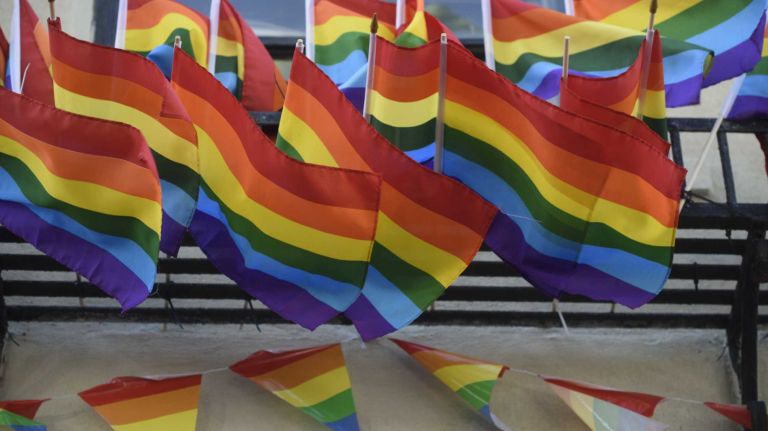 Flags fly in front of The Stonewall Inn in Manhattan on Sunday, June 12, 2016, at a vigil for the victims of the mass shooting attack in Orlando, Fla. A gunman armed with an assault rifle and handgun killed 49 people and wounded 53 at Pulse, a gay nightclub in Orlando, in what officials termed the worst mass shooting in U.S. history.