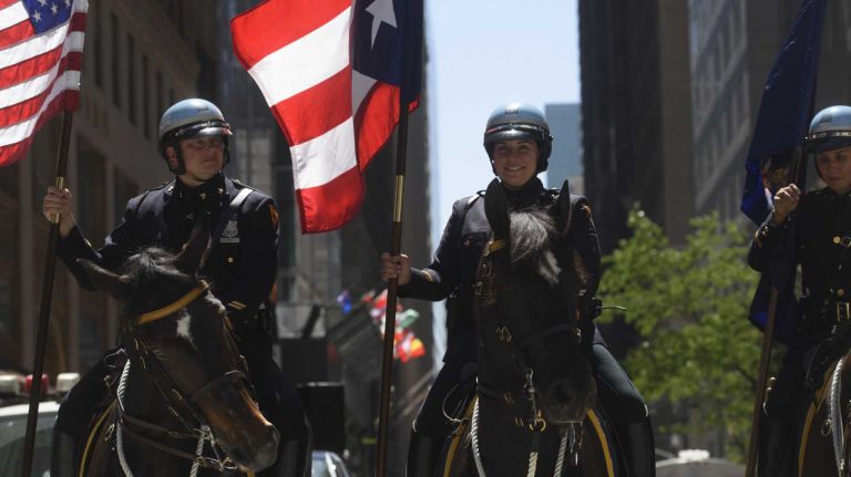 Members of the NYPD's Mounted Unit ride along Fifth Avenue during the 59th annual Puerto Rican Day Parade in Manhattan on Sunday, June 12, 2016. 