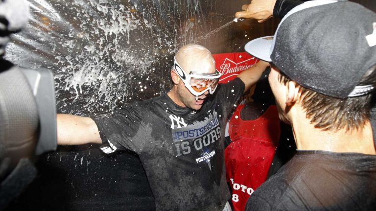 Brian McCann #34 of the New York Yankees celebrates in the locker room after defeating the Boston Red Sox at Yankee Stadium on Thursday, Oct. 1, 2015.