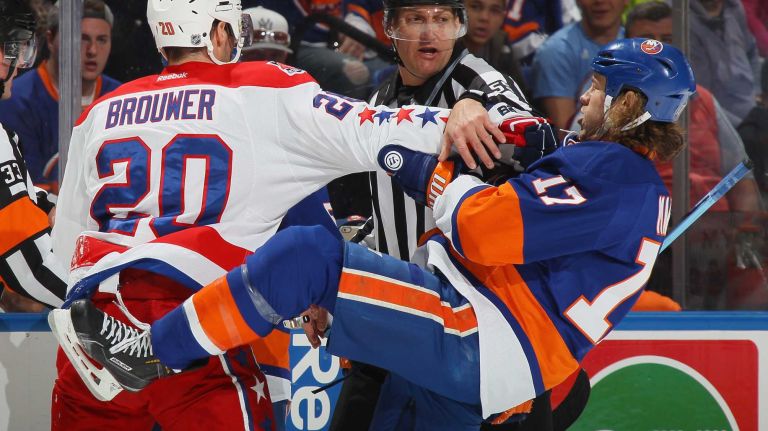 Troy Brouwer #20 of the Washington Capitals pushes Matt Martin #17 of the New York Islanders during the first period in Game 3 of the Eastern Conference quarterfinals during the 2015 NHL Stanley Cup playoffs at the Nassau Veterans Memorial Coliseum on April 19, 2015.