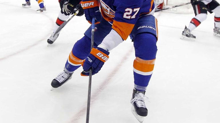 Anders Lee of the New York Islanders tries to control the puck against the Ottawa Senators in the first period at Nassau Coliseum on Friday, March 13, 2015.