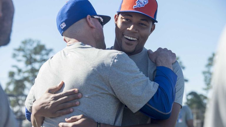 New York Mets pitcher Jeurys Familia is greeted by coaches during a spring training workout, Wednesday, Feb. 17, 2016 in Port St. Lucie, Fla.