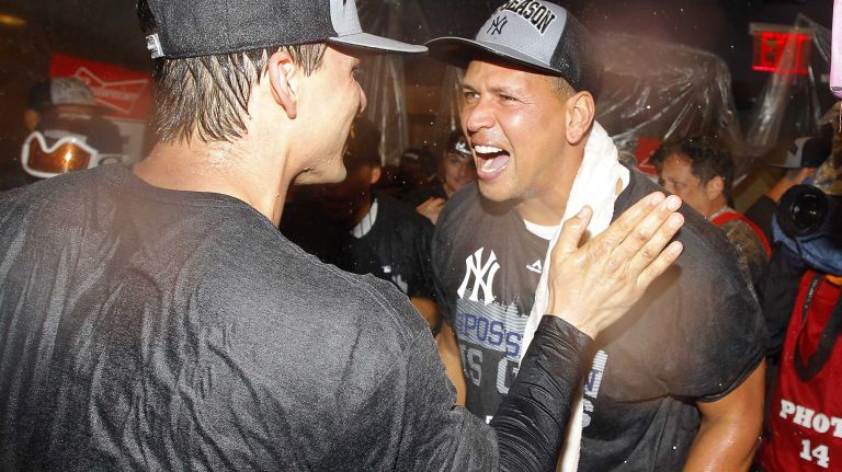 John Ryan Murphy and Alex Rodriguez of the New York Yankees celebrate in the locker room after defeating the Boston Red Sox at Yankee Stadium on Thursday, Oct. 1, 2015.