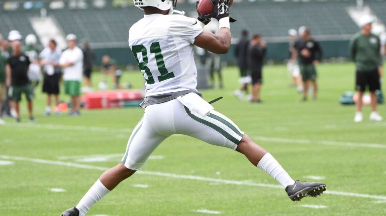New York Jets wide receiver Shaq Evans (81) catches a pass from quarterback Geno Smith (7) during practice at the Jets' Atlantic Health Training Center on Monday, August 10, 2015 in Florham Park, N.J.