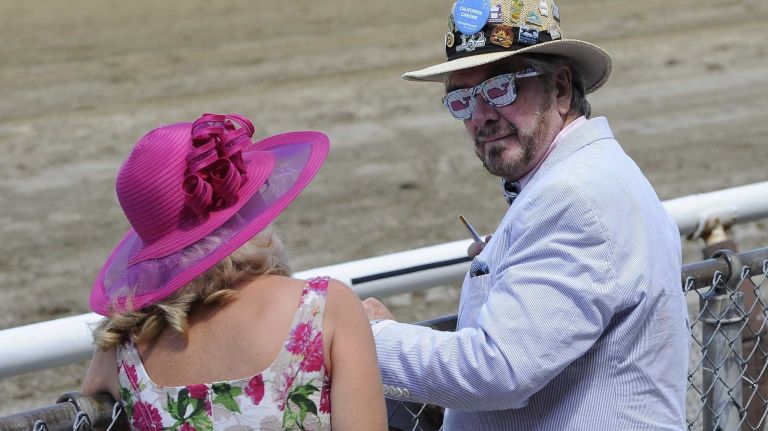 Charles and Anne Clarke stand at the rail at the 146th running of the Belmont Stakes on Saturday, June 7, 2014 at Belmont Park in Elmont.