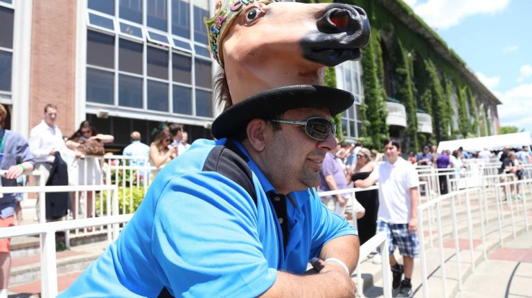 Carlos Spano of Lindenhurst, wears a big horse hat at the 146th running of the Belmont Stakes on Saturday, June 7, 2014, at Belmont Park in Elmont.