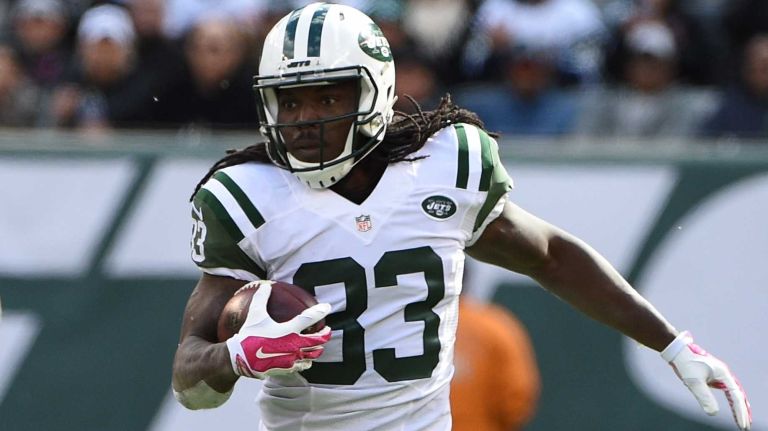 New York Jets running back Chris Ivory (33) runs the football against the Washington Redskins during the first half of an NFL football game at MetLife Stadium on Sunday, Oct. 18, 2015.