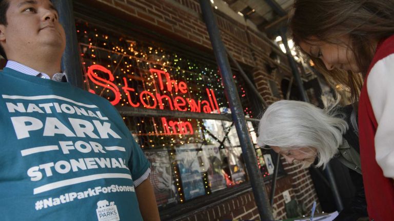 People sign a petition outside of the Stonewall Inn in Manhattan to designate it as the first ever national park site honoring America's LGBT history on Sunday, Sept. 20, 2015. 