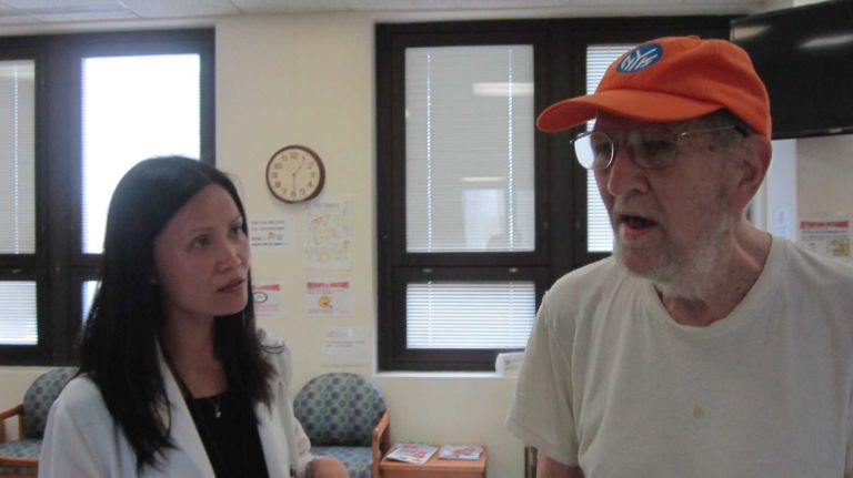 Jenny Chen, a nurse practitioner at the VA NY Harbor Healthcare System talks to Bernhardt Wichmann III about his health care: communicating is much easier, said Wichmann, now that his voice has returned, after disappearing 32 years ago following an operation for vocal chord polyps. 