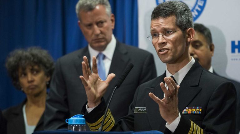 Dr. Matthew Moore of the CDC addresses members of the media about the Legionnaires' outbreak during a news conference at Lincoln Hospital in the Bronx on Thursday, Aug. 13, 2015, as New York City Health Commissioner Dr. Mary Bassett and Mayor Bill de Blasio listen. 