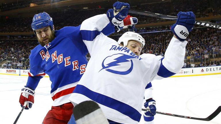 Tanner Glass of the New York Rangers battles for position  in the first period against Brenden Morrow10 of the Tampa Bay Lightning during Game 7 of the Eastern Conference Finals at Madison Square Garden on Friday, May 29, 2015.