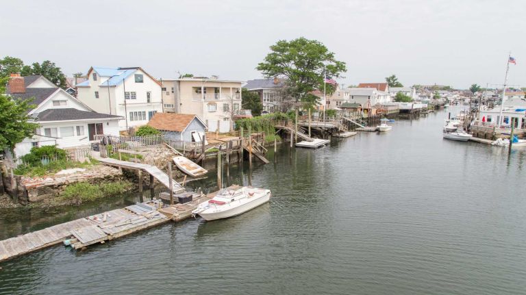 Views of homes from the Hawtree Basin Bridge for pedestrians in Howard Beach on June 23, 2015.