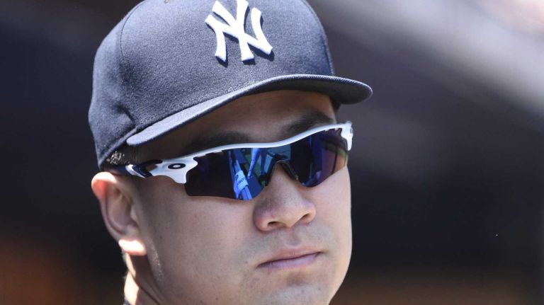 New York Yankees pitcher Masahiro Tanaka looks on from the dugout before a baseball game against the Los Angeles Angels at Yankee Stadium on Sunday, June 7, 2015.
