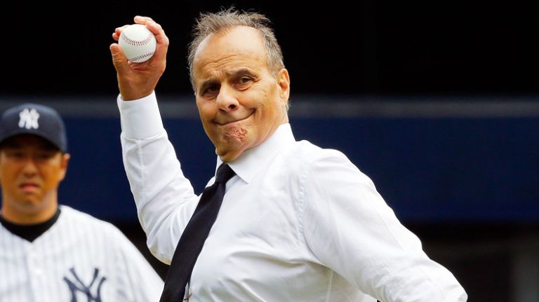 Former Yankee manager Joe Torre throws out the ceremonial first pitch before a game against the Chicago White Sox as Hiroki Kuroda #18 looks on at Yankee Stadium on Aug. 23, 2014.