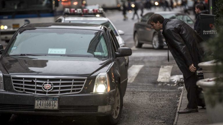 Yellow taxi owners, drivers sue TLC over Uber 2 A pedestrian hails a Uber taxi on 5th Avenue in Manhattan.