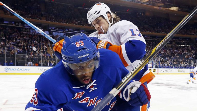 Anthony Duclair of the Rangers is checked in the second period by Matt Martin of the Islanders at Madison Square Garden on Tuesday, Oct. 14, 2014.