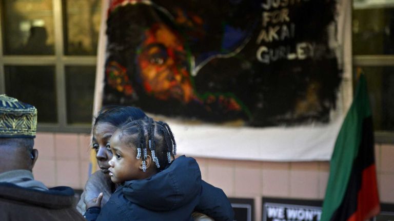 Akaila Gurley, 2, with family at a rally for her late father Akai, 28, at the Louis H. Pink Houses public housing project in the East New York section of Brooklyn on Saturday, Dec. 27, 2014.