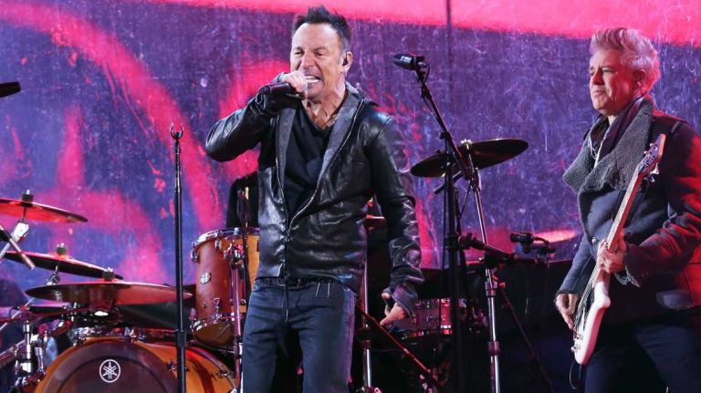 Bruce Springsteen plays with U2 at the World AIDS Day concert in Times Square, Manhattan, Dec 1, 2014.