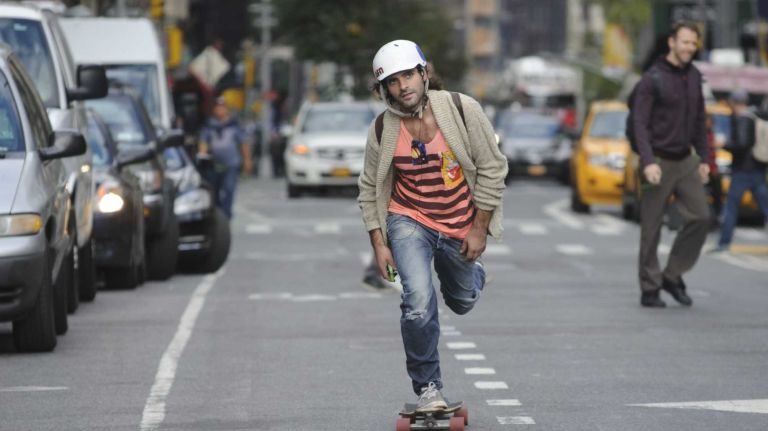 Thaddaeus Timothy, a Brooklyn designer, rides a skateboard on Broadway near Union Square Park on October 21, 2014.