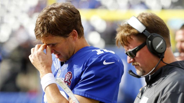 Eli Manning #10 of the Giants and offensive coordinator Ben McAdoo stand on the sidelines late in a game against the Arizona Cardinals at MetLife Stadium on Sunday, Sept. 14, 2014 in East Rutherford, N.J.