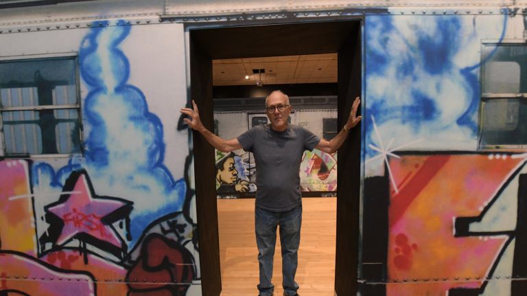 Photographer Henry Chalfant with some of his work&nbsp;in the exhibit "Henry Chalfant: Art vs. Transit, 1977-1987" at The Bronx Museum. &nbsp;