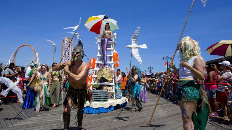 Participants pull a float as they march in the annual Coney Island Mermaid Parade on Saturday, June 21, 2014.