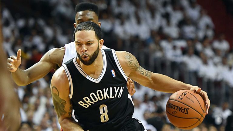 Deron Williams driving to the basket against Miami Heat's Norris Cole in the second quarter of Game 2 in the second round of the NBA playoffs at AmericanAirlines Arena in Miami on May 8, 2014.