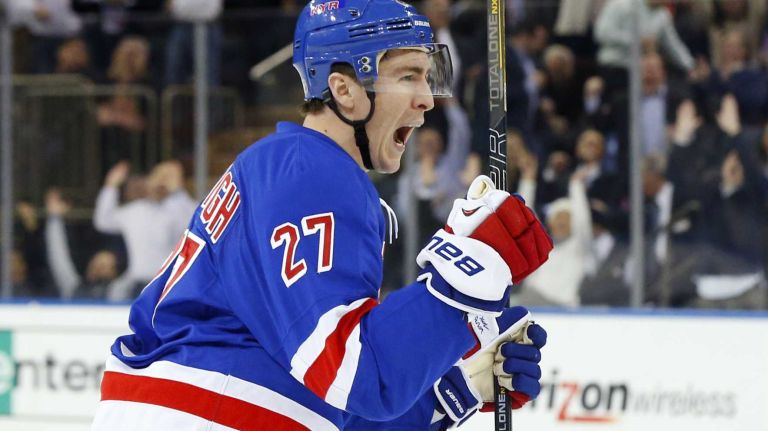 Ryan McDonagh celebrates after assisting on teammate Dan Girardi's game-tying third period goal on March 24, 2014.