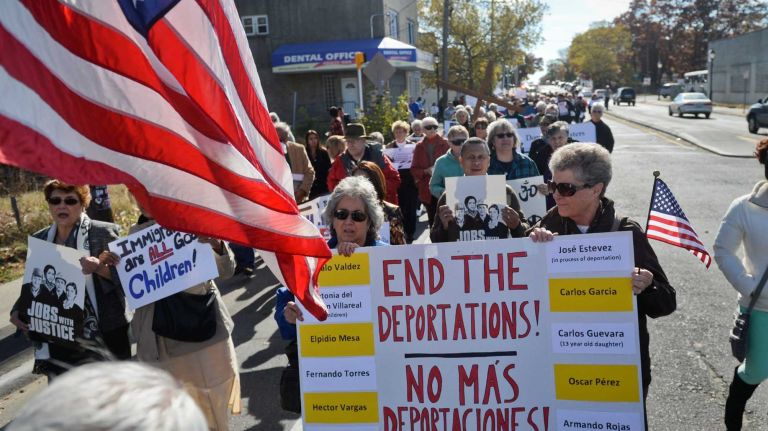 People of faith and community members march down Straight Path in Wyandanch in an interfaith show of support for the passage of an immigration reform bill that would putl 11 million people on a path to citizenship. (Oct. 27, 2013)