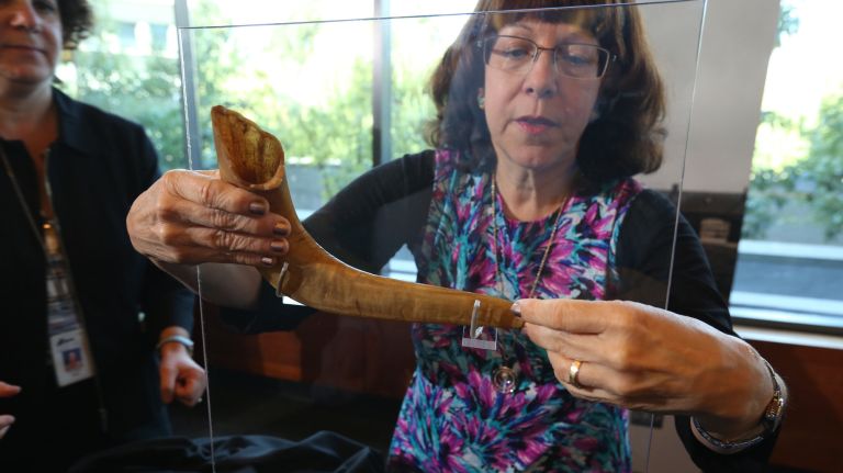 Professor Judith Tydor Baumel-Schwartz with&nbsp;a&nbsp;shofar that is a relic from Auschwitz&nbsp;that her family donated to the exhibit "Auschwitz. Not long ago. Not far away." at the Museum of Jewish Heritage.