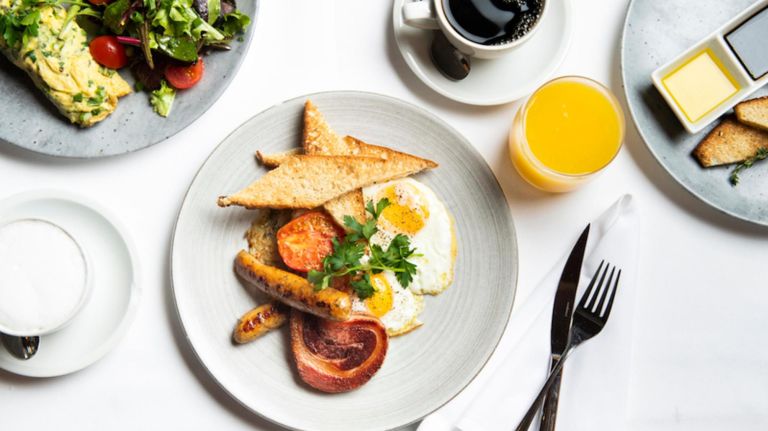 One of Fig and Olive's special Memorial Day brunch items is the Provençal breakfast with eggs, hash browns, sausage, pancetta and stuffed Kumato tomato.