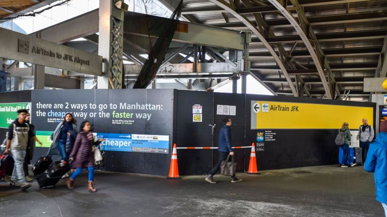 On March 22, passengers pass the area at Jamaica Station  where construction is underway on a new platform at the south end of the terminal. 