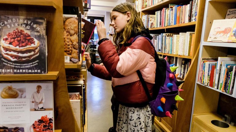 Ever Smith, 11, browses cookbooks at Archestratus Bookstore on Huron Street.
